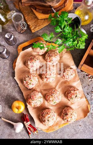Raw meatball over wooden background ready for cooking Stock Photo - Alamy