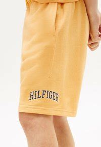 Tommy Hilfiger VARSITY WIDE - Tracksuit bottoms - faded sun kiss/orange ...
