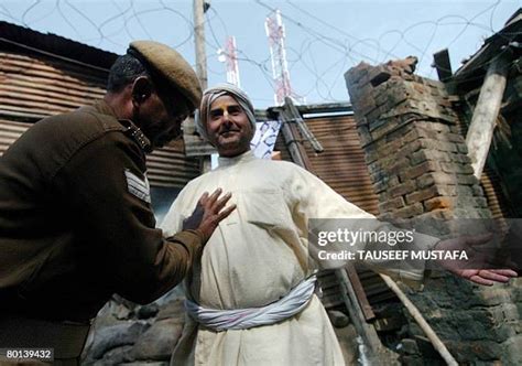 An Indian Central Reserve Police Force soldier searches a Kashmiri ...