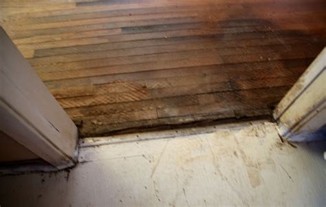 Appears to be water damage to wood floors at entry to kitchen from ...