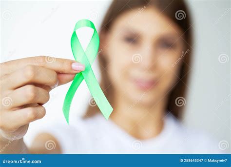 Green Ribbon in Hand As Symbol To Awareness Lymphoma Cancer Stock Image ...