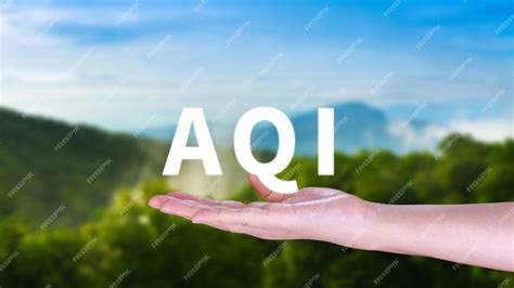 Premium Photo | AQI Abbreviation of air quality index hand holding AQI on nature background ...