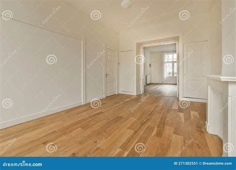 A Living Room with White Walls and a Wood Floor Stock Image - Image of ...