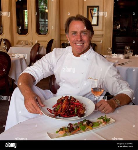 Chef John Besh poses with a "French Crawfish Boil" which consists of ...