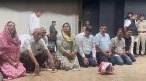 Members of the Marwari community kneel down in apology
