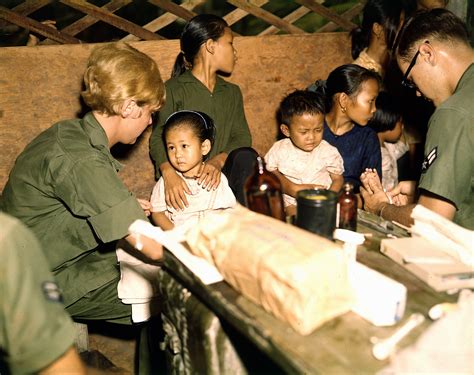 Nurse treats a Vietnamese child, 1967 during the Vietnam War image ...