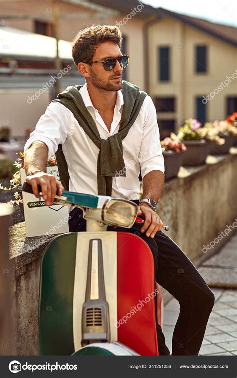 Stylish italian man wearing white shirt and sitting on classic s Stock ...