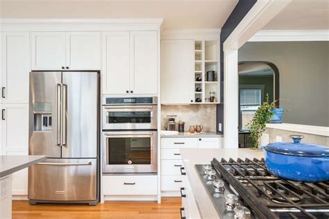Stainless steel appliances complement white shaker cabinets for an ...