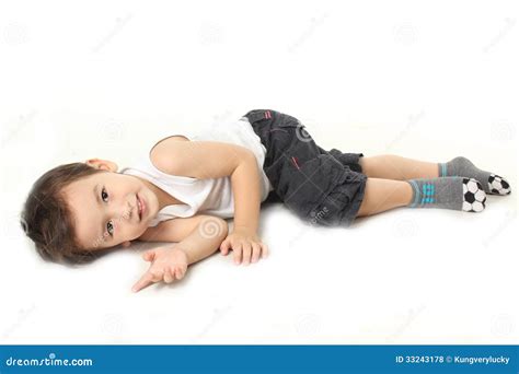Boy lie down on the floor stock photo. Image of little - 33243178