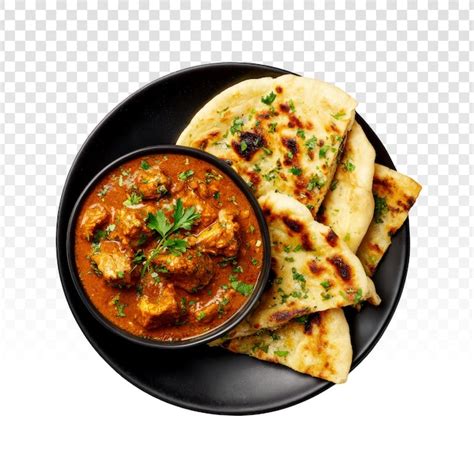 Delicious chicken curry with naan bread on a black plate | Free PSD