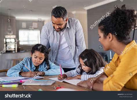 Child Doing Homework With Parent