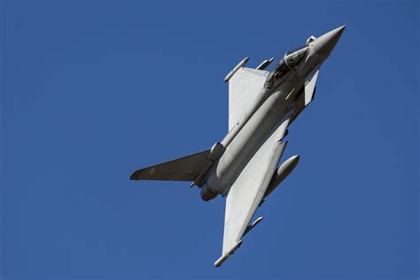Royal Air Force ground crew preparing an RAF Typhoon fighter jet. It is night-time and the team are