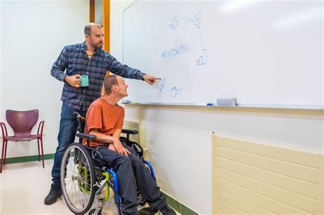 Man with disability and work team during brainstorming indoors ...