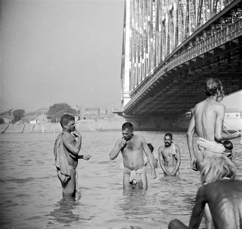 Men bathe in the Hooghly River, Calcutta (Kolkata) under the shadow of ...