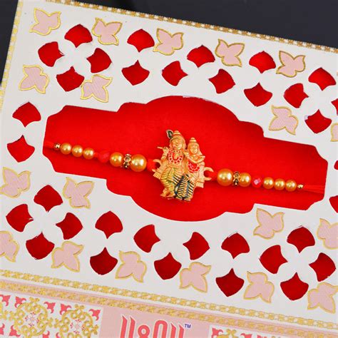 Send Sacred Golden Radha Krishna Rakhi Online | Rakhibazaar.com