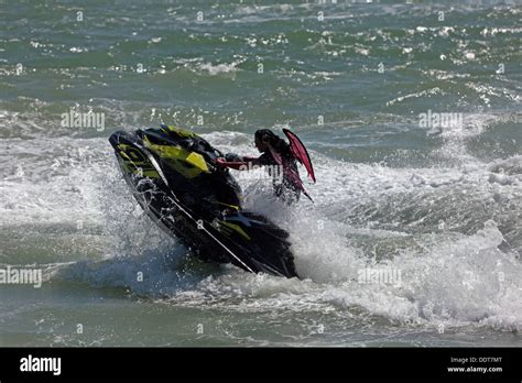 A woman performing a stunt on her Sea-Doo Spark with the words “Make Waves sales event”