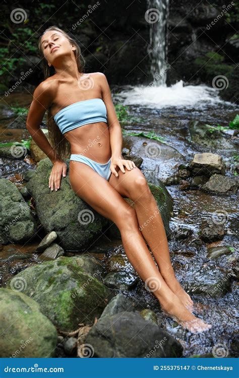 Beautiful Young Woman in Light Blue Bikini Relaxing on Rock Near ...