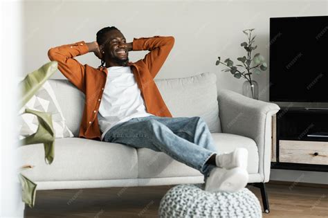 Premium Photo | Rest concept Happy black man sitting on comfortable ...