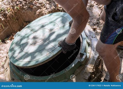 The Man Opens the Sewer Hatch. Installation and Maintenance of Septic ...