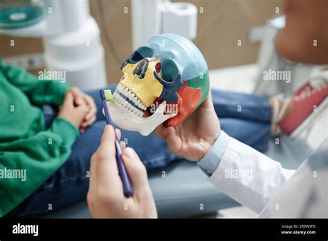 Dentist carrying out dental procedure on male patient, close-up