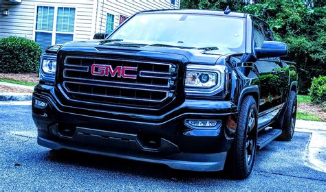 Black GMC Truck Parked in Front of a House