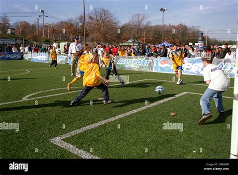 Children playing soccer on small scale pitch outside foxboro stadium hi ...