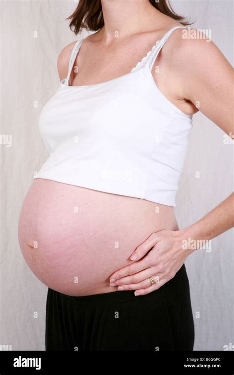 Closeup of pregnant womans stomach bump at 40 weeks 9 months Stock ...