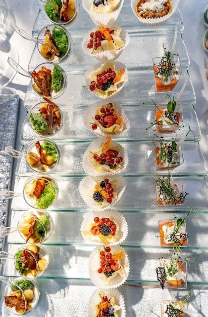 Top view of the lot of cold desserts with berries and fruits standing ...