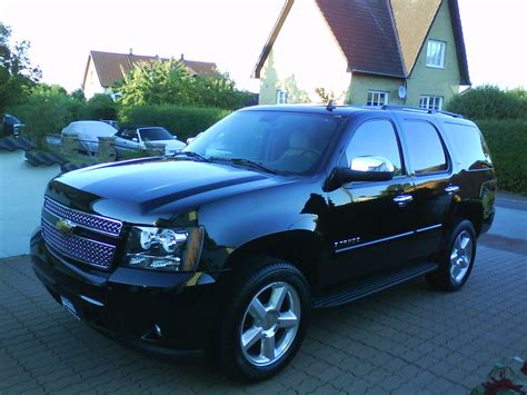 2008 Chevrolet Tahoe LTZ 4WD - Black SUV Parked in Front of House