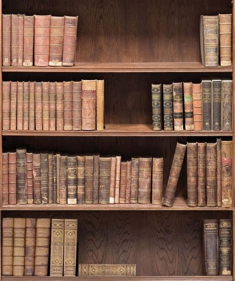 Download A Wooden Bookcase With Many Old Books | Wallpapers.com