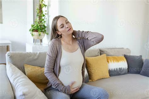 pregnant woman suffer nrck and shoulder pain. pregnant woman holding ...
