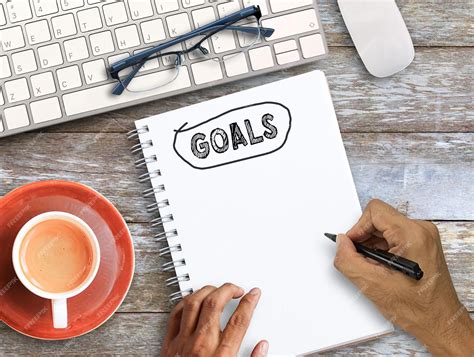 Premium Photo | Top view with handwriting goals on notebook