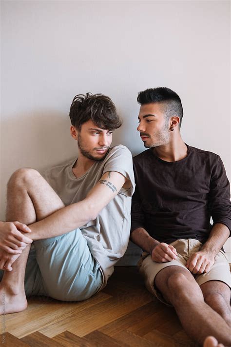 "Young Gay Couple Relaxing" by Stocksy Contributor "Studio Serra" - Stocksy