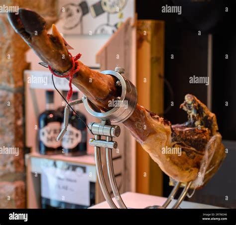 Leg of pork serrano Iberian cured jamon on stand in Spanish butcher's ...