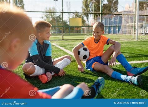 Teenage Boys Football Team Talking on Soccer Field Stock Photo - Image ...