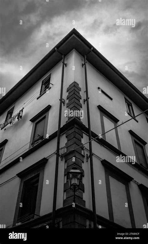 A black and white photograph of an aged building with a clear view of ...