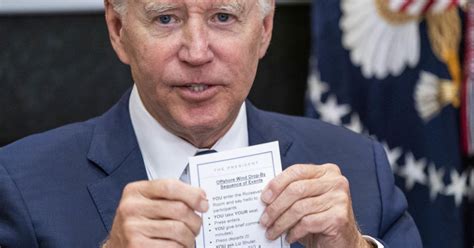 Biden holds notes that read 'YOU enter the Roosevelt Room,' 'YOU take ...