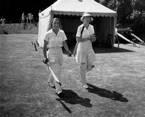 Betty Snowball (left) and T Dutton walk out to open the batting ...