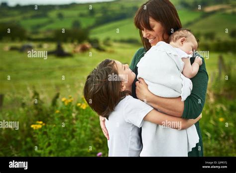 Hugging Mom with some warmth and love. a mother and her two little kids ...