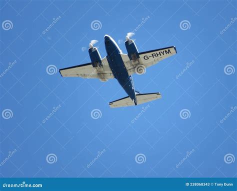 Twin Engine Propeller Aircraft Flying in Clear Blue Sky Editorial Stock ...