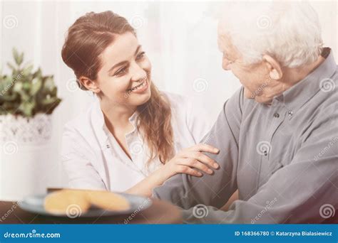 Volunteer Smiling at Senior Man at Nursing Home Stock Photo - Image of ...