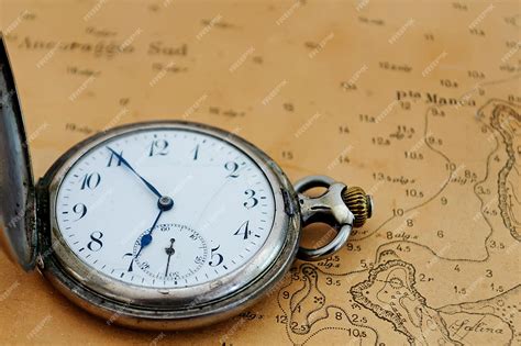 Premium Photo | Old fob watch on a old nautical map
