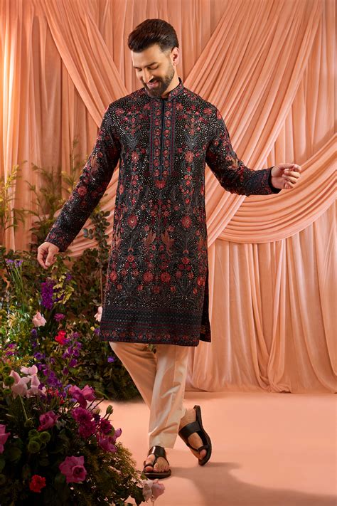 A black kurta elevated with heavy sequin work and intricate flora and ...