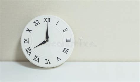 Closeup White Clock for Decorate Show 8 O`clock on White Wood Desk and ...