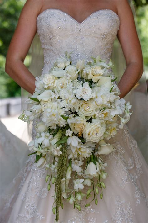 Cascade bouquet with white orchids, white peonies, cream roses, white ...