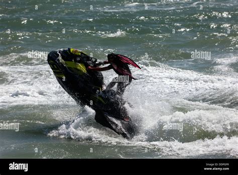 A woman performing a stunt on her Sea-Doo Spark with the words “Make Waves sales event”
