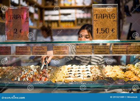 Waitress Serving a Tapa, Typical Spanish Appetizer, in the Window of a ...