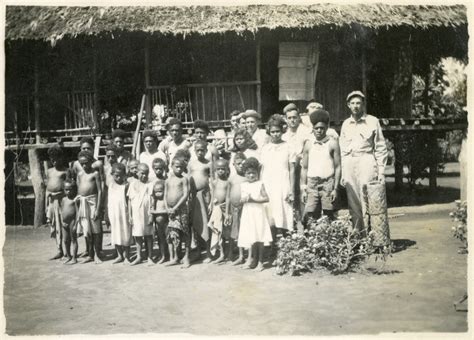 Soldiers pose with villagers at an unknown location on Papua New Guinea ...