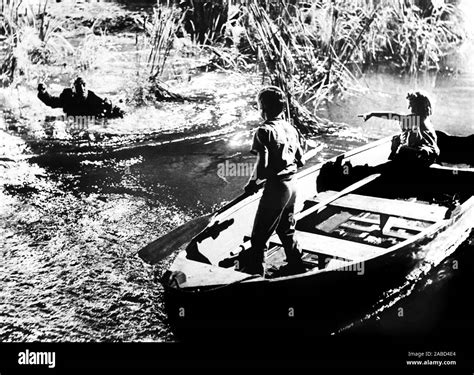 THE NIGHT OF THE HUNTER, from left, Robert Mitchum, Billy Chapin, Sally ...
