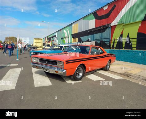 old red 1970s Dodge Polara RT coupe by Chrysler Argentina on a colorful industrial background ...